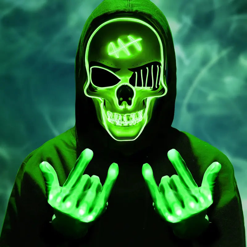 Hoodie-wearer with green light-up skeleton skull face mask and glowing hands