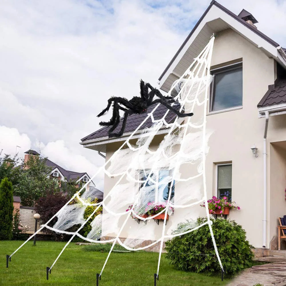 Large white triangle spider web decor with black spider on a house exterior