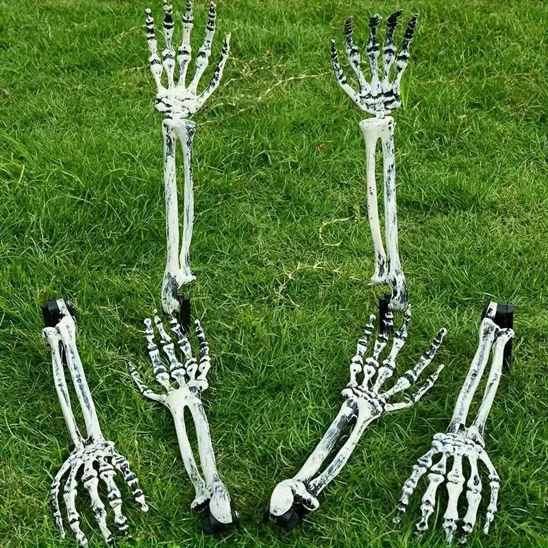 Assorted skeleton hand garden stakes arranged on green grass, white-gray