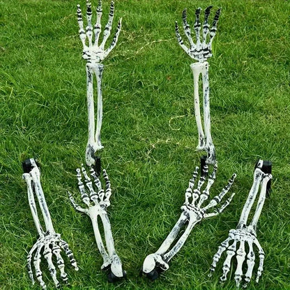 Assorted skeleton hand garden stakes arranged on green grass, white-gray