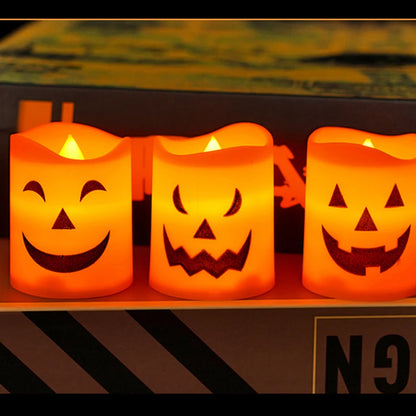Glowing LED pumpkin candle lights with jack-o’-lantern carved smile and grin