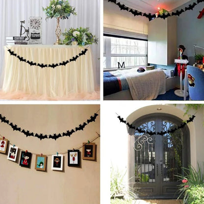 Black bat paper garland strung across a room for Halloween party decor