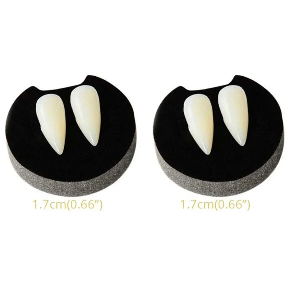 Vampire fang dentures with two ivory pointed teeth on black gum pieces, pair shown