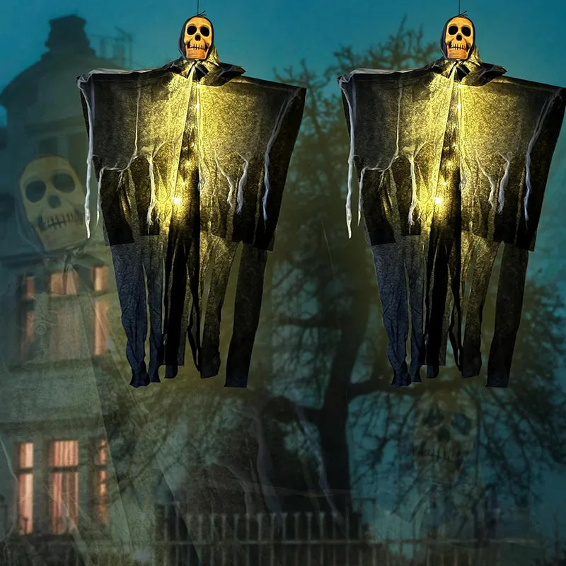 Pair of glowing skeleton gauze hanging ghosts with warm-lit skull faces