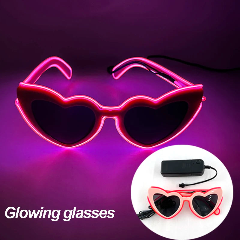 Pink heart-shaped LED neon glasses with battery pack and red wiring.
