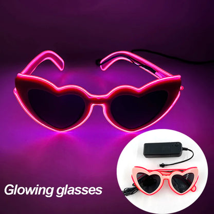 Pink heart-shaped LED neon glasses with battery pack and red wiring.