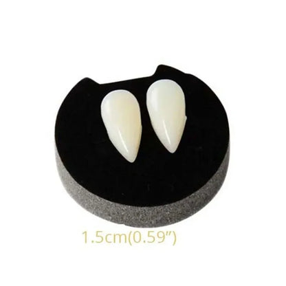 Single vampire fang denture with two off-white pointed teeth on a black gum base