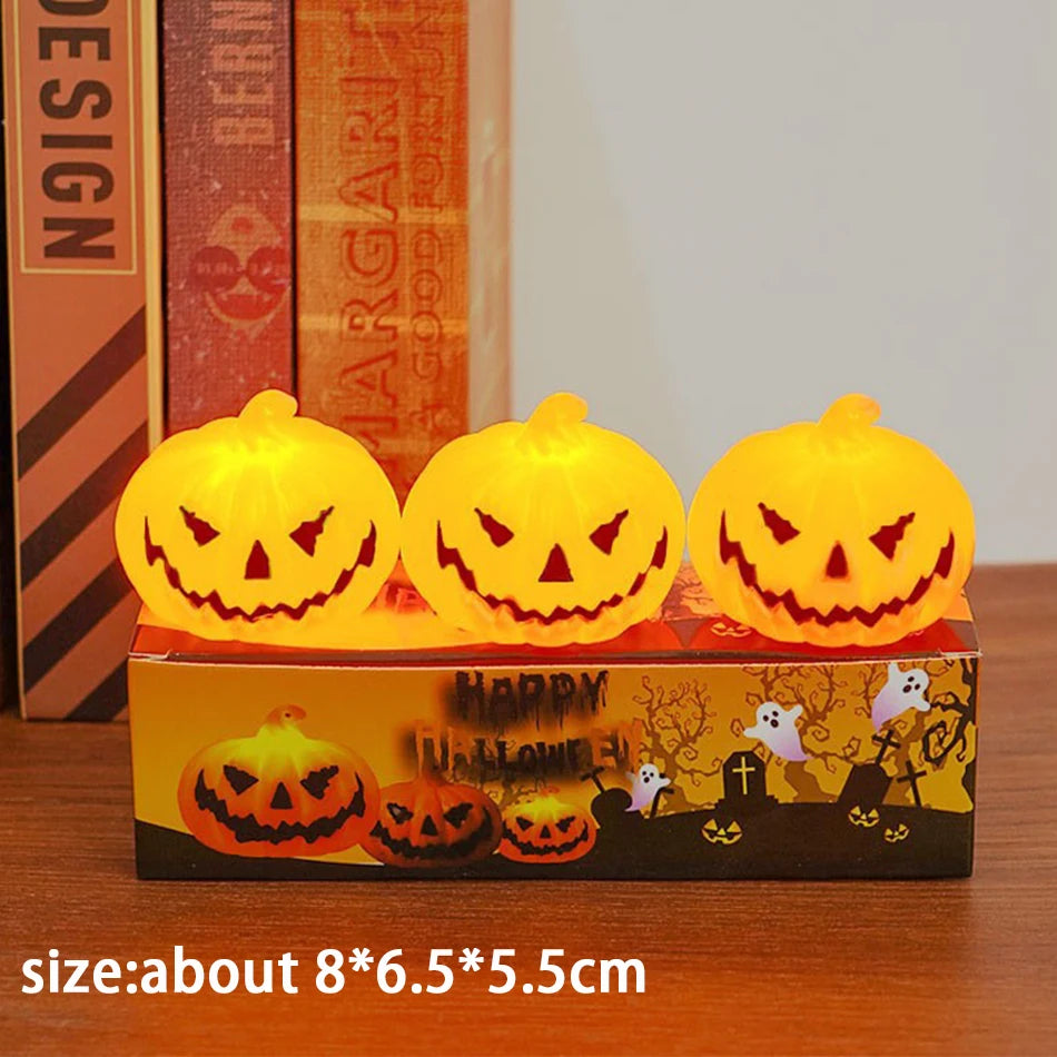 Three glowing orange LED pumpkin candle lights with jack-o’-lantern carved faces