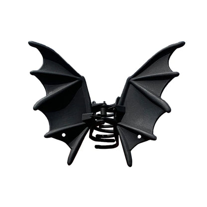 Black bat hair clip with pointed wings and spring clasp, front view