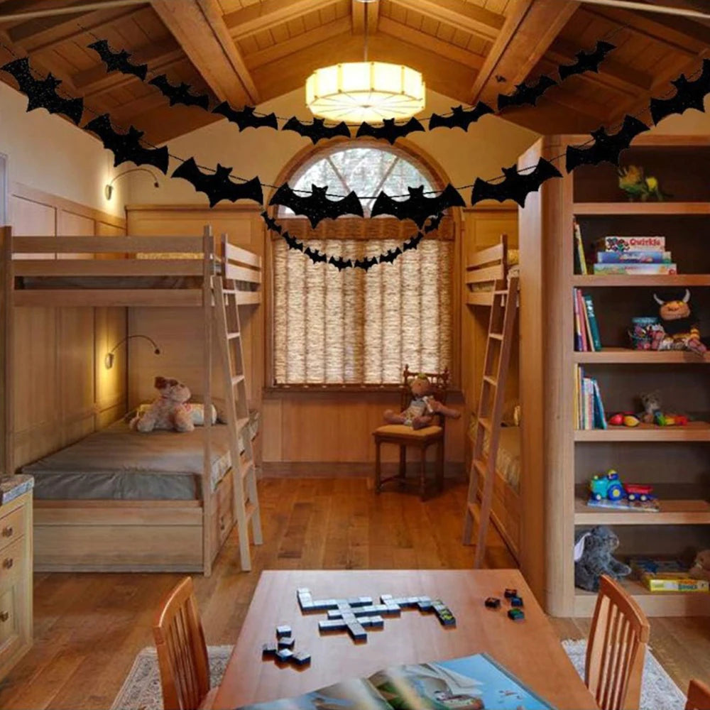 Bat paper hanging garland overhead with repeating black bat cutouts
