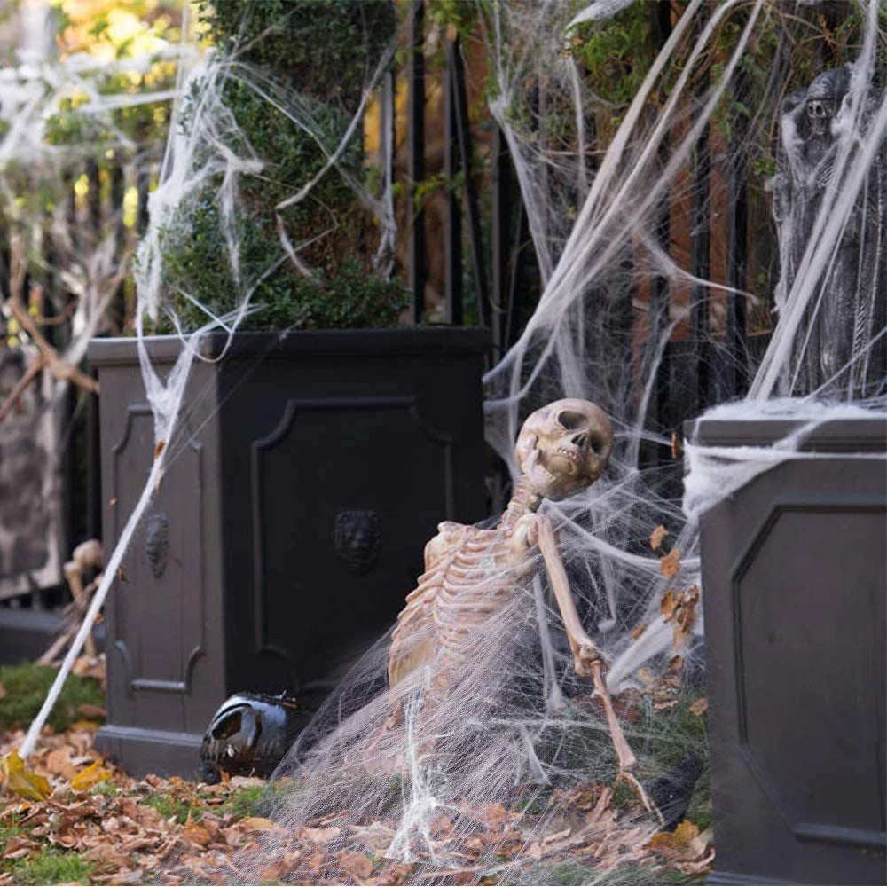 Hanging skull prop with skull head and gray sheet, spiderweb-like strands around it