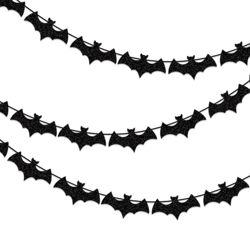 Black paper bat garland with repeating bat cutouts along a curved banner