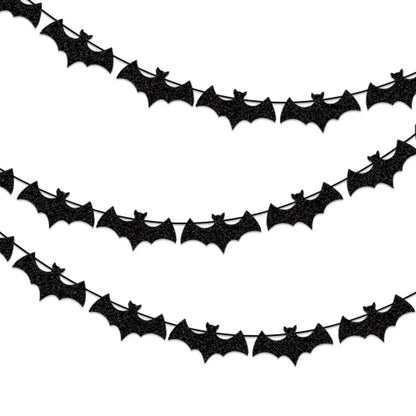 Black paper bat garland with repeating bat cutouts along a curved banner