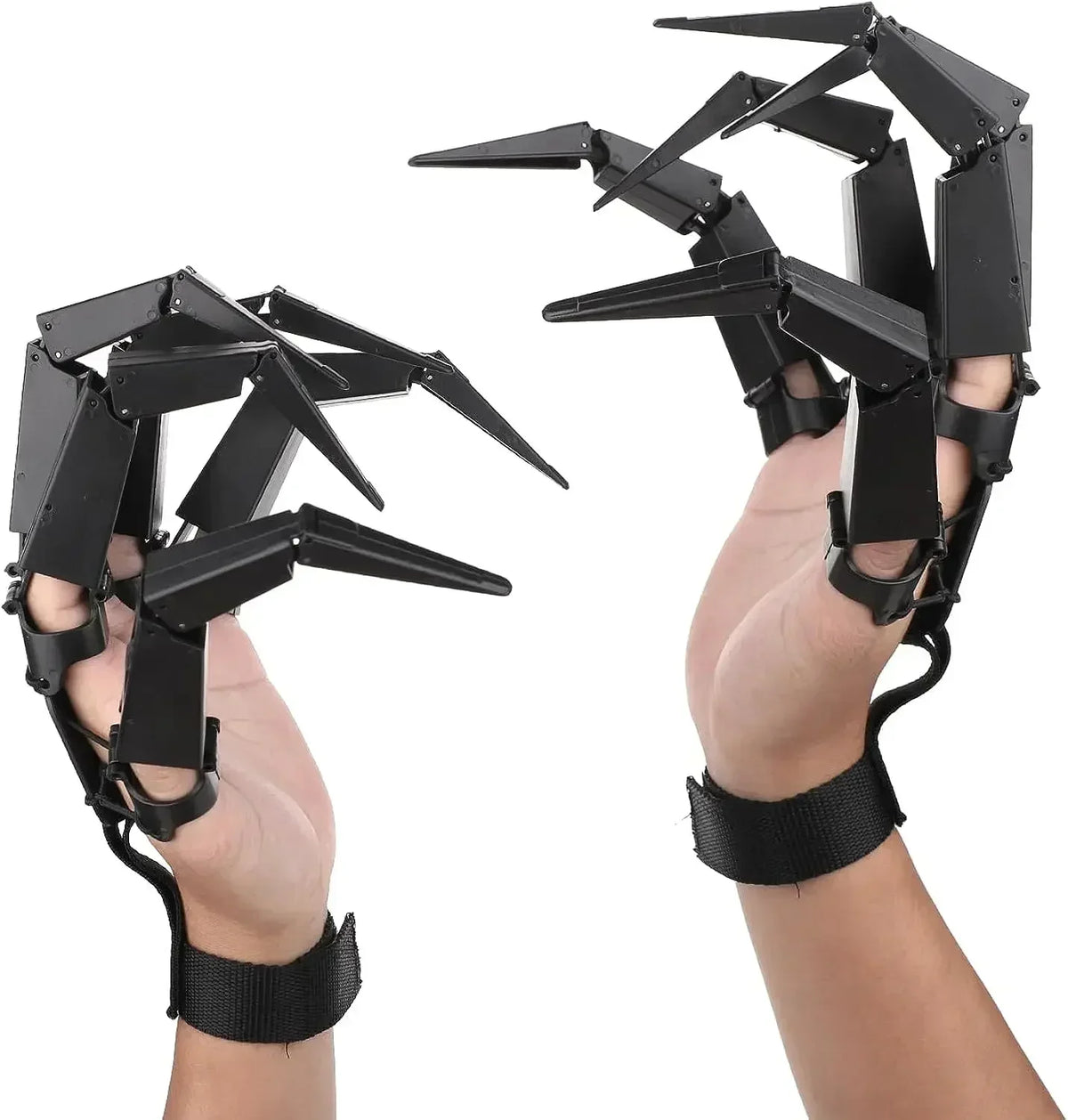 Articulated skeleton finger claw props on hands with black spiked finger pieces and wrist straps