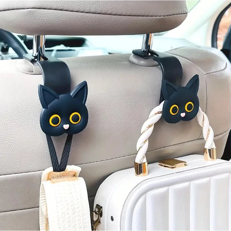 Set of 2 black cat headrest hooks with 3D faces and curved mounting straps