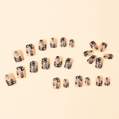 Square short press-on nails with black designs and small blue and pink star details
