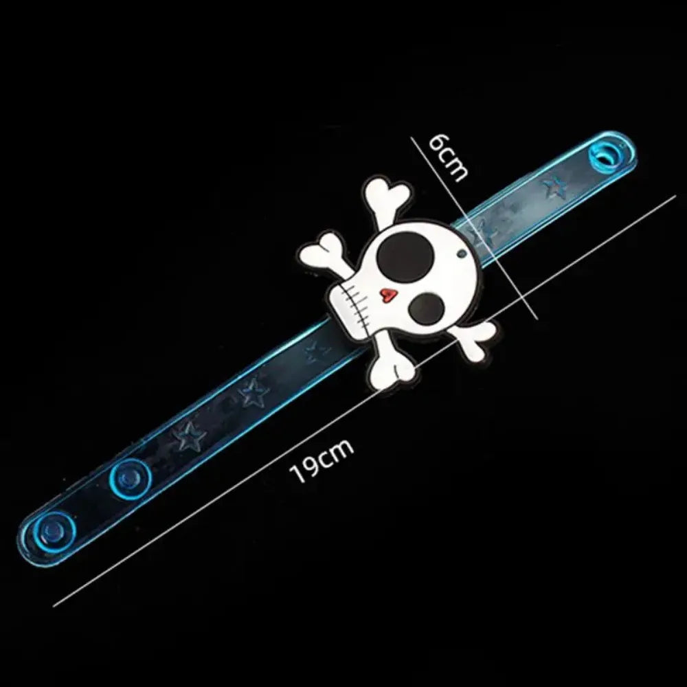 Glow-in-the-dark skull wrist bracelet with blue light-up band and pirate graphics