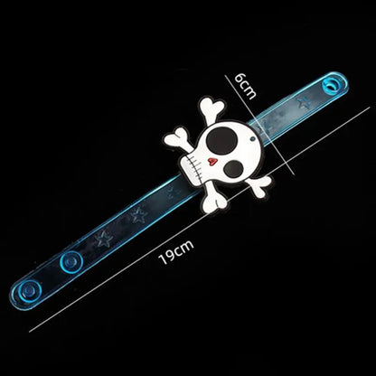Glow-in-the-dark skull wrist bracelet with blue light-up band and pirate graphics