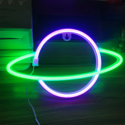 LED neon wall decor with green and purple UFO outline with antenna