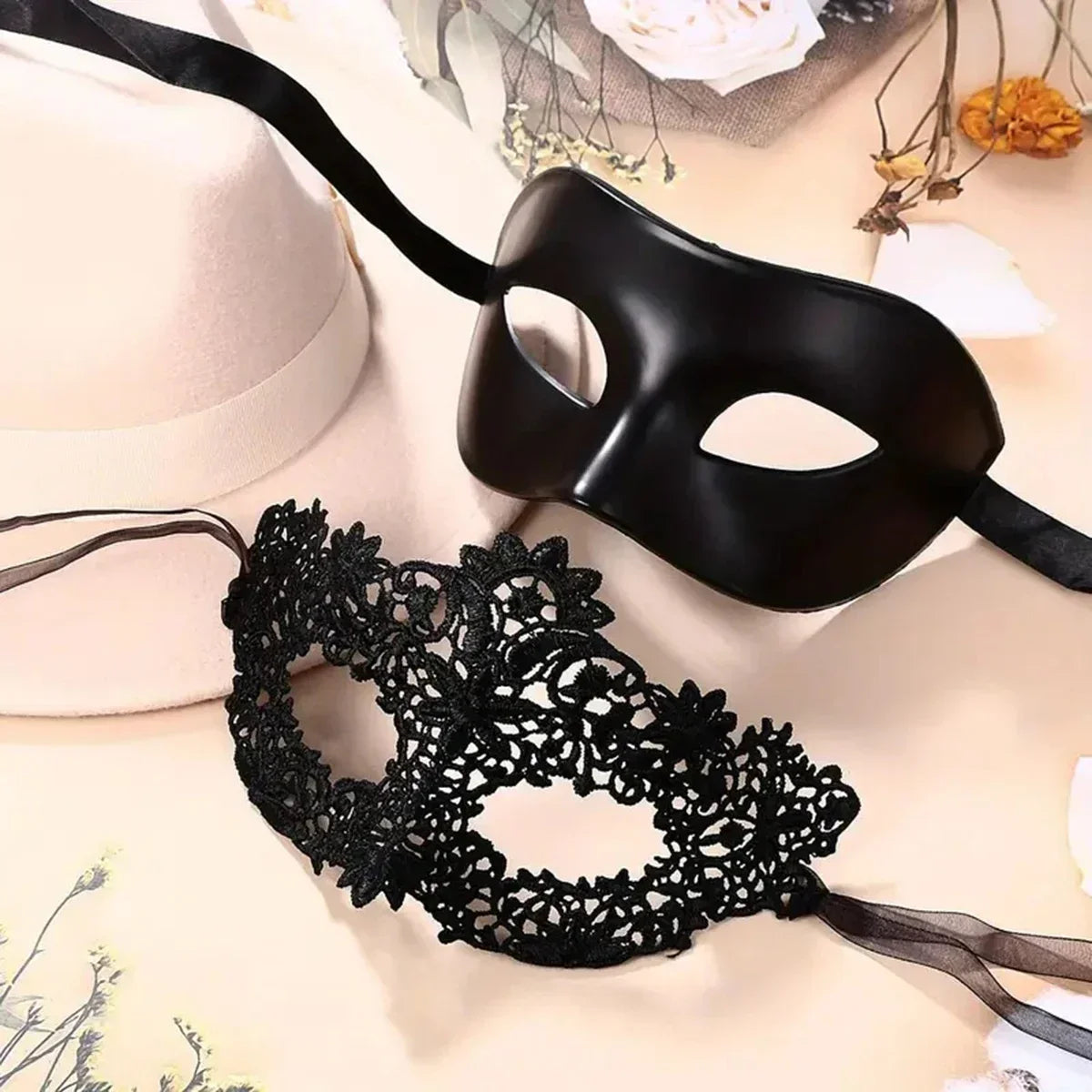 Black molded eye mask with cutout eyes and black lace eye mask with ribbon ties