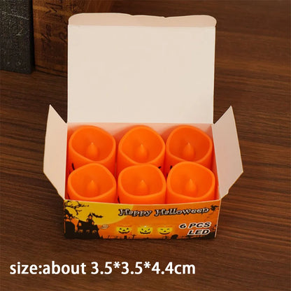 Boxed set of orange LED pumpkin candle lights with glowing jack-o’-lantern faces