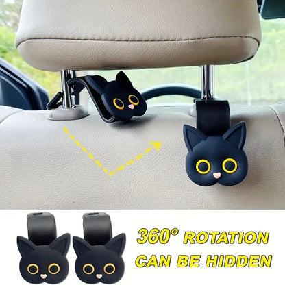 Two black cat headrest hooks on car seat back with visible rotating strap