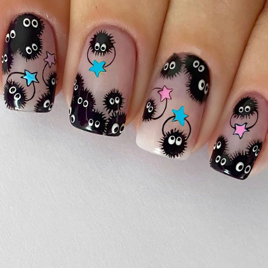 Square short press-on nails with black monster faces, blue and pink stars