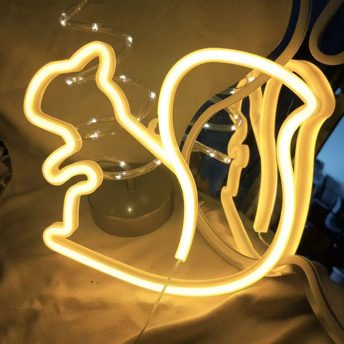 Warm yellow LED neon wall decor featuring glowing bat-like and curved horn shapes
