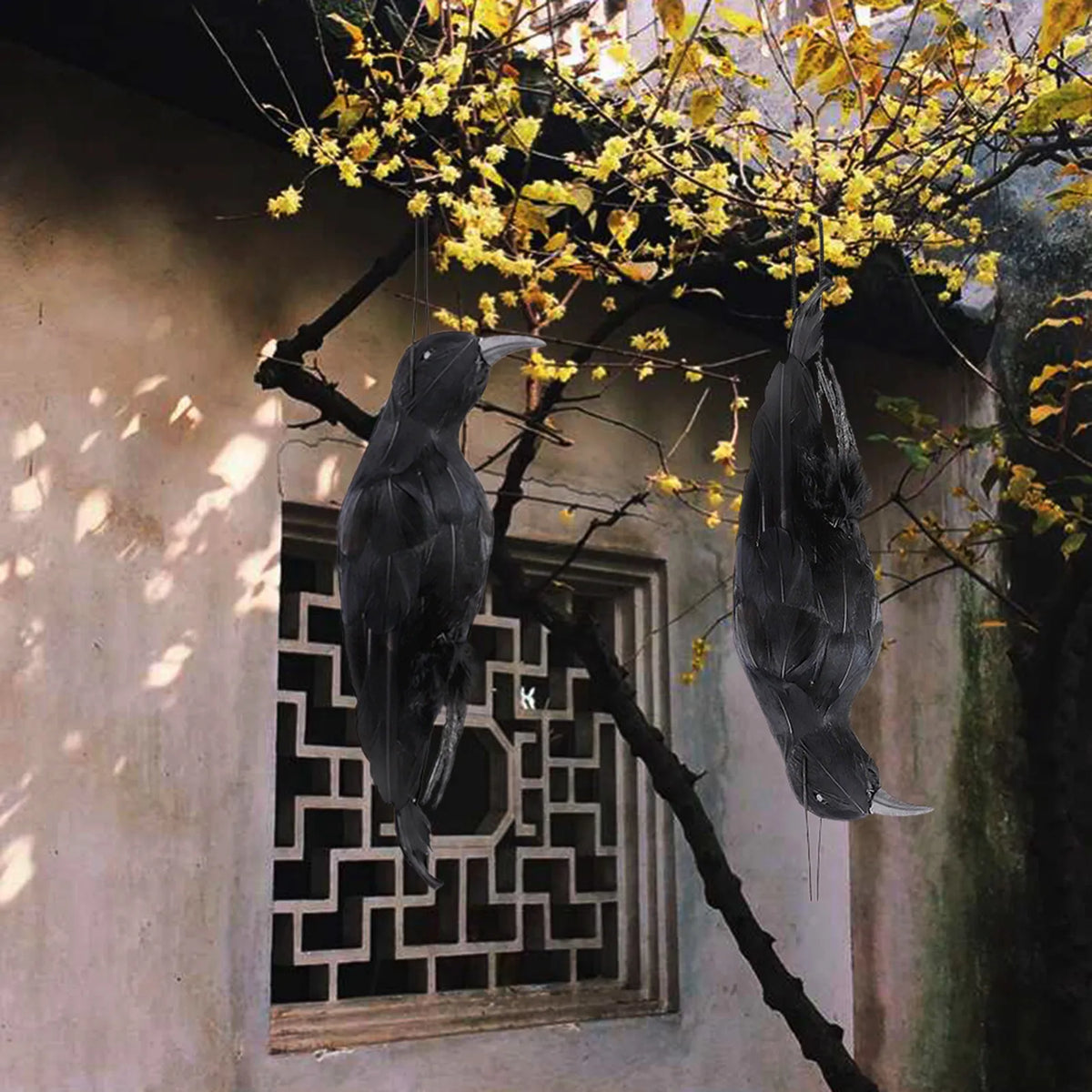 Black hanging crow prop with detailed wing feathers and top suspension loop