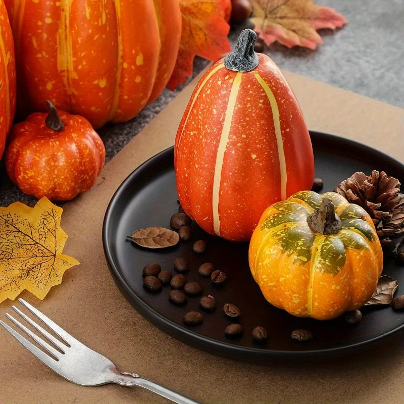 Artificial pumpkin decor set: orange faux pumpkins on a dark plate with fall leaves.