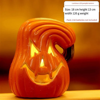 Orange LED pumpkin lantern showing curved jack-o'-lantern face, warm light glowing