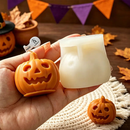 Orange jack-o’-lantern candle next to white silicone mold cavity held in hand